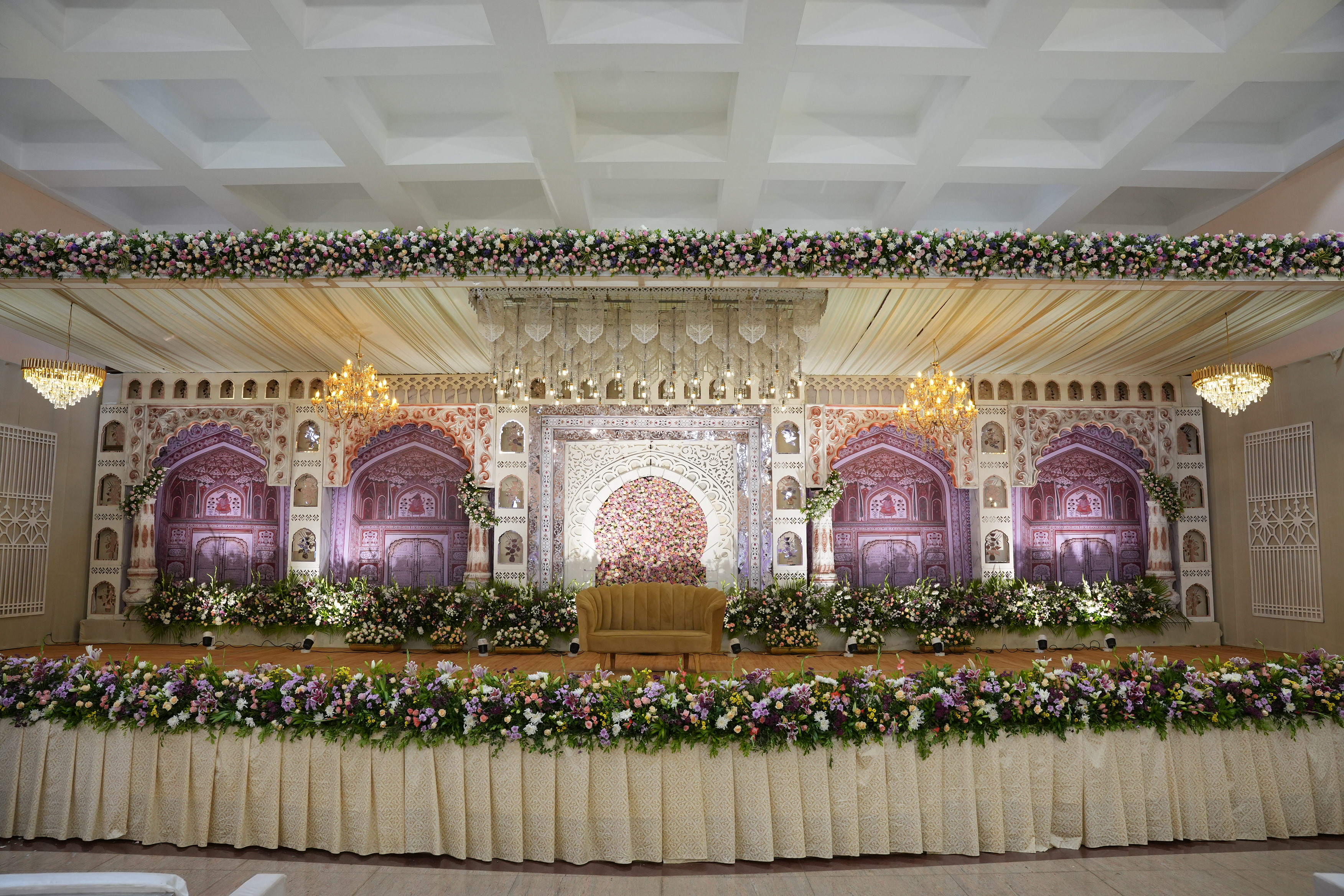 Stunning event decoration with candlelight, florals, and dramatic architecure