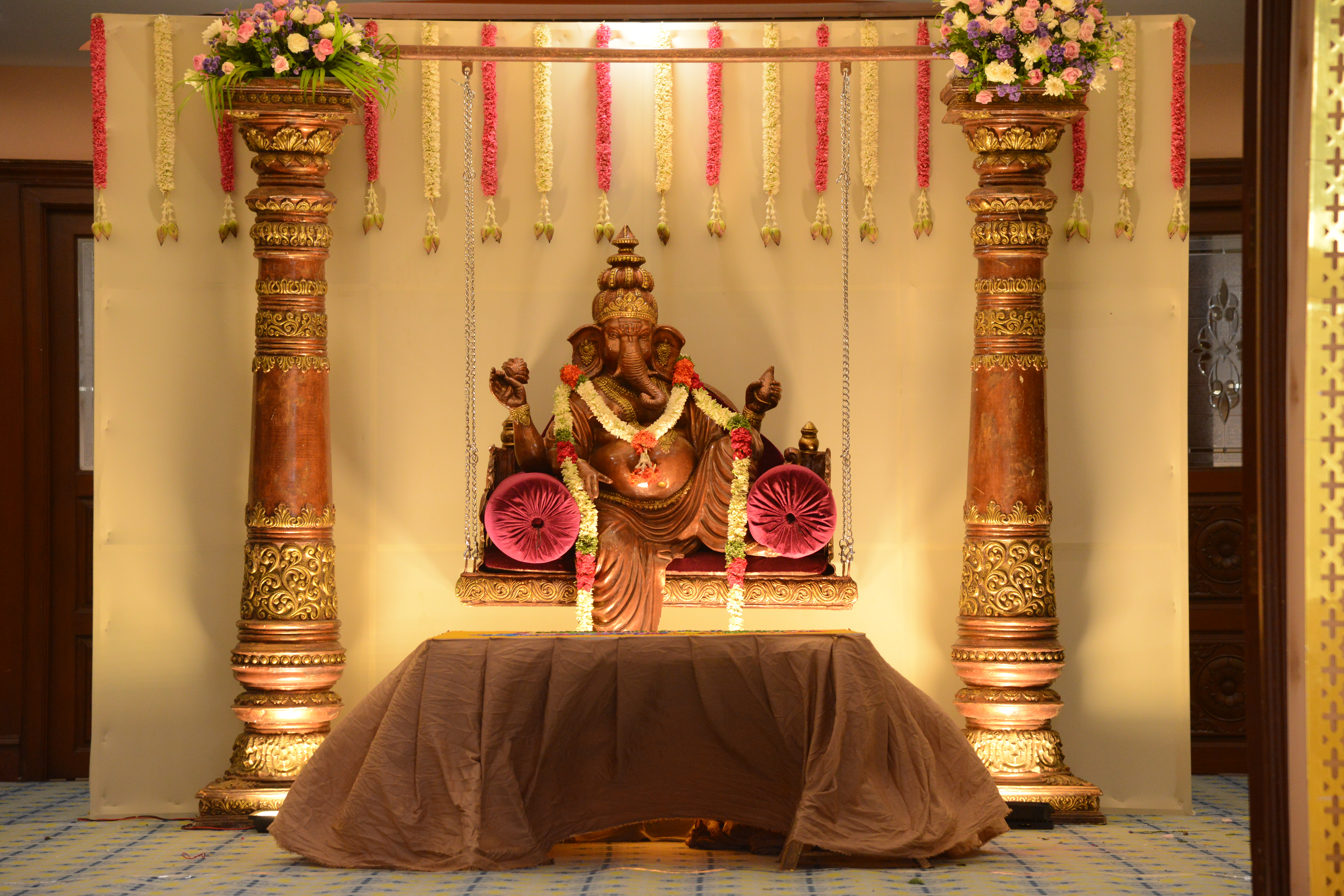Grand wedding stage with crystal chandeliers and cascading florals